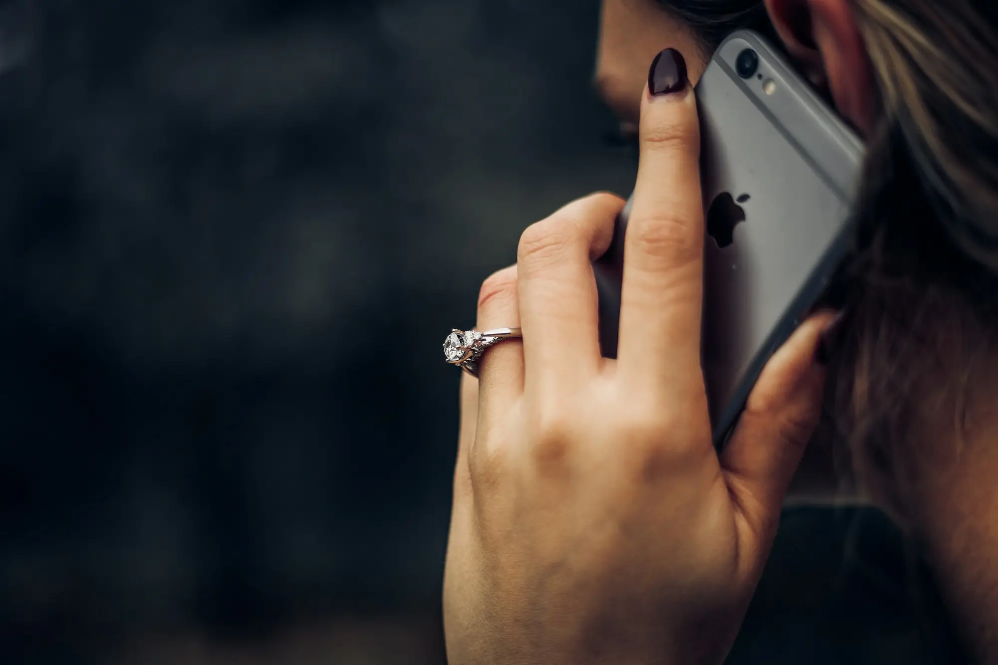 Woman talking on her mobile phone while sorting out a loan question